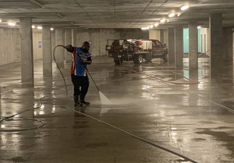 an expert cleaner washing a parking lot